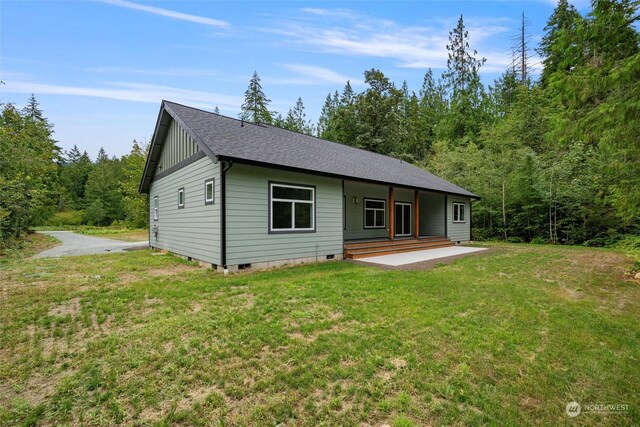 rear view of property with a lawn