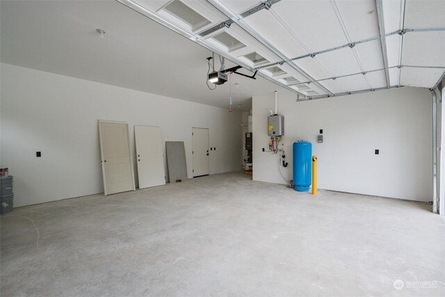 garage featuring water heater and a garage door opener