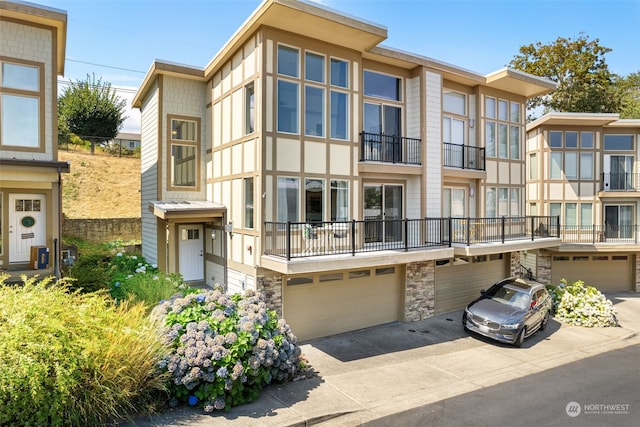 multi unit property featuring a garage and a balcony