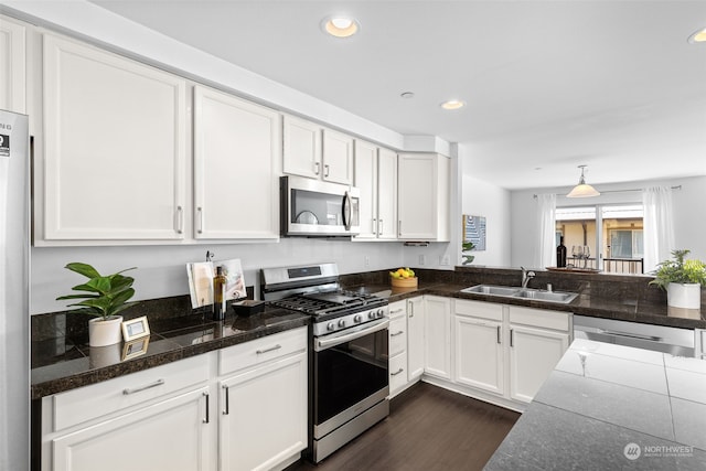 kitchen featuring sink, white cabinets, stainless steel appliances, and dark wood-type flooring