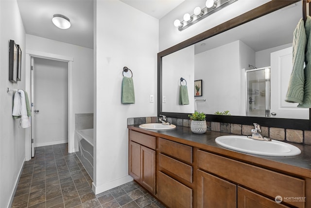 bathroom with dual bowl vanity, tile patterned flooring, and separate shower and tub