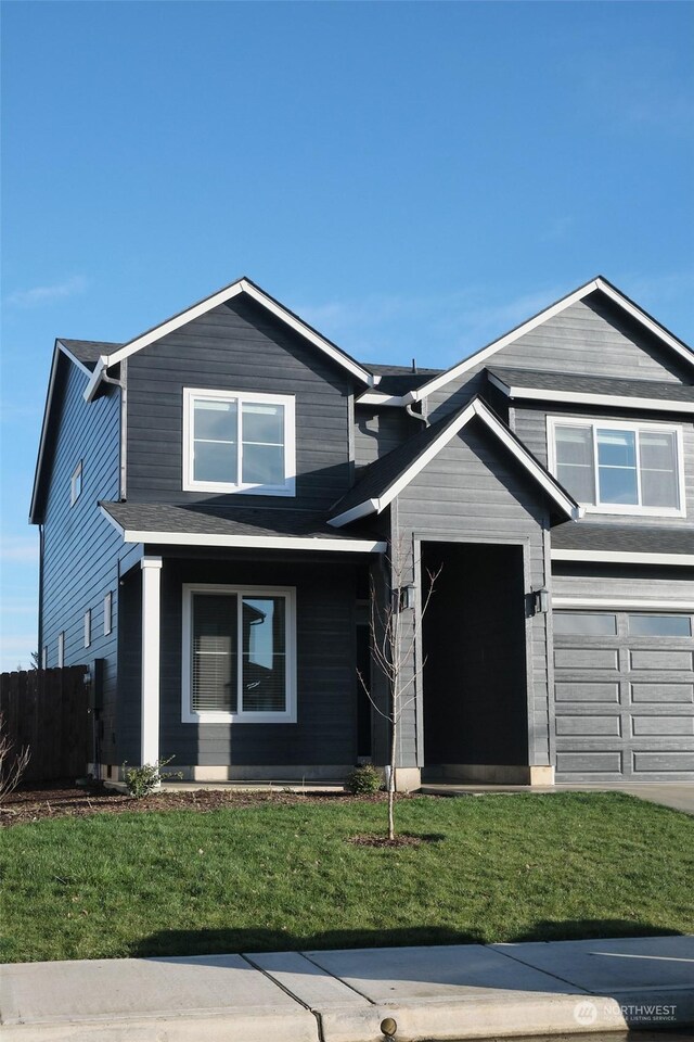 view of front of house with a front lawn and a garage