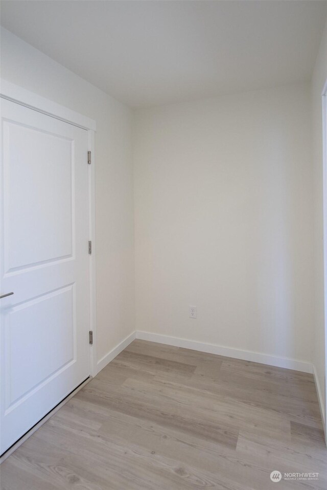 empty room with light hardwood / wood-style flooring