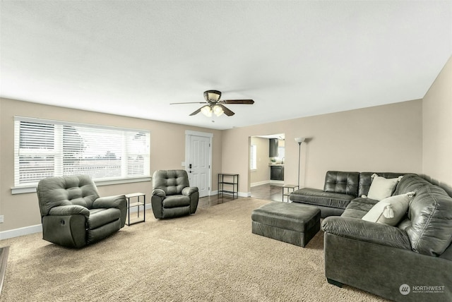 carpeted living room with ceiling fan