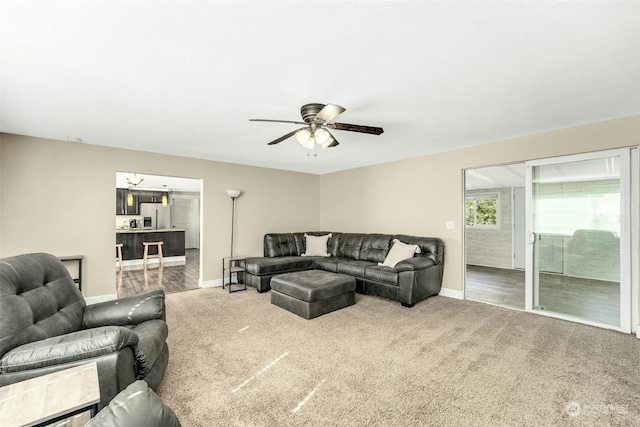 living room featuring ceiling fan and carpet