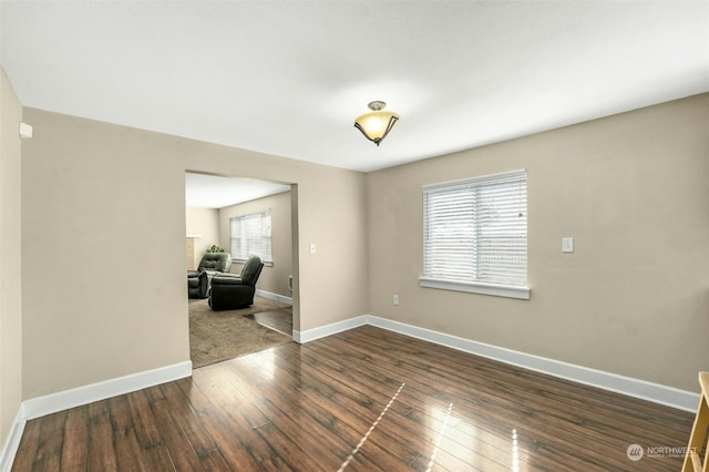 unfurnished room featuring dark wood-type flooring