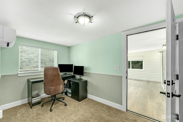 carpeted office space featuring a wall mounted air conditioner