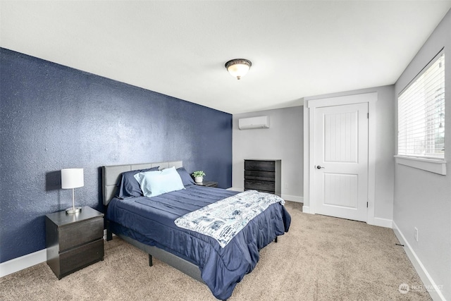 bedroom with carpet flooring and a wall unit AC