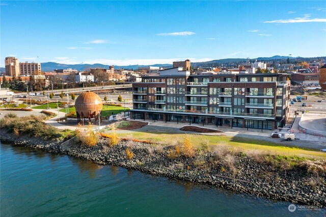 drone / aerial view featuring a water and mountain view