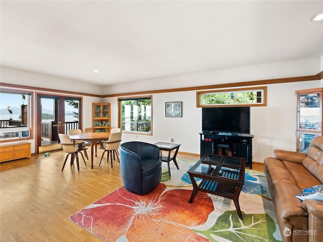 living area with light wood-style floors, recessed lighting, french doors, and baseboards