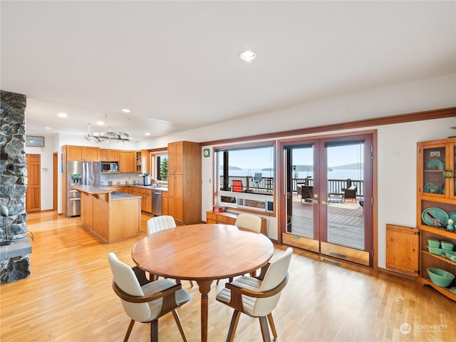 dining space with recessed lighting, french doors, visible vents, and light wood finished floors