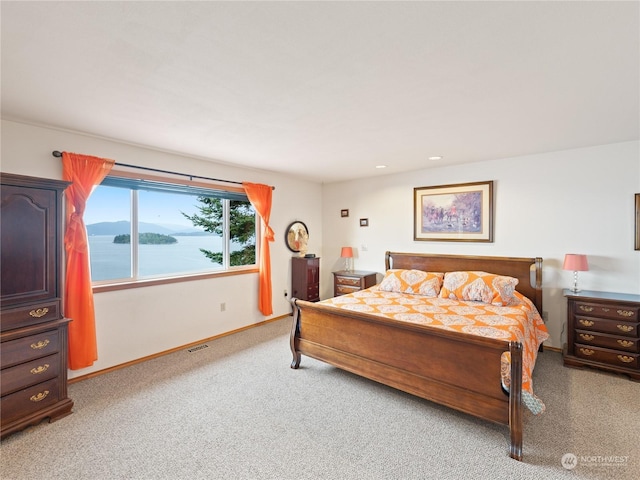 bedroom with recessed lighting, visible vents, light carpet, and baseboards