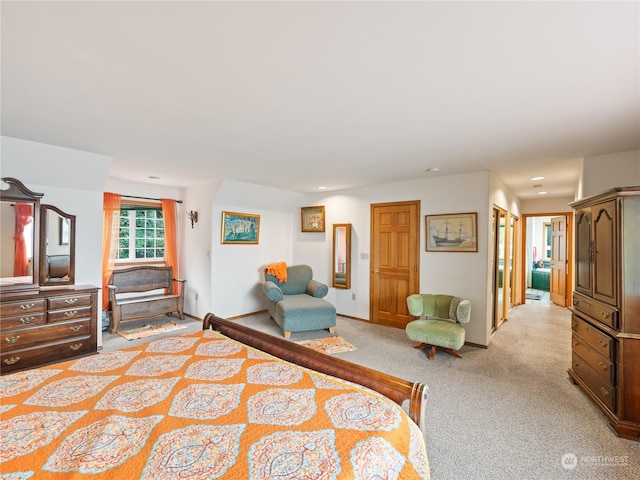 bedroom with baseboards and light colored carpet