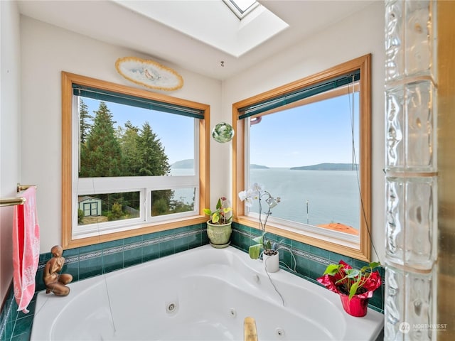 full bathroom featuring a tub with jets and a skylight