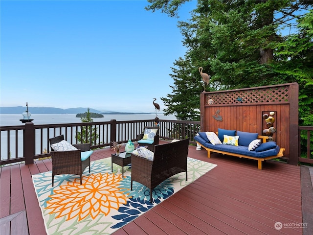 wooden terrace with a mountain view and an outdoor living space