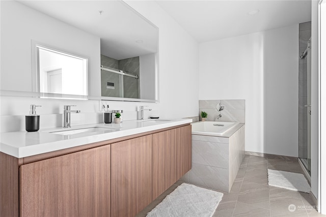 bathroom with vanity and shower with separate bathtub