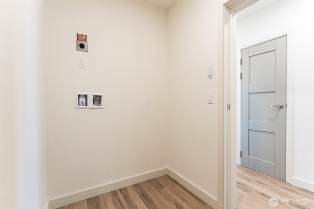 clothes washing area featuring laundry area, washer hookup, light wood-type flooring, and hookup for an electric dryer