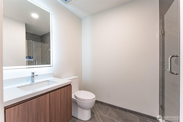 full bathroom with a stall shower, vanity, toilet, and tile patterned floors