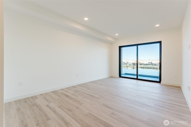 unfurnished room with baseboards, recessed lighting, and light wood-style floors