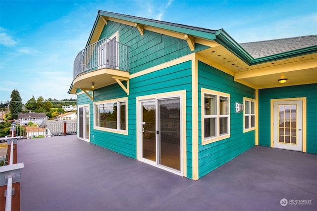 view of side of home with a patio area