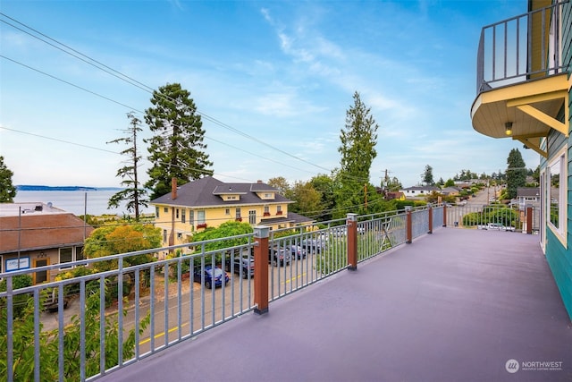 view of patio / terrace with a balcony and a water view