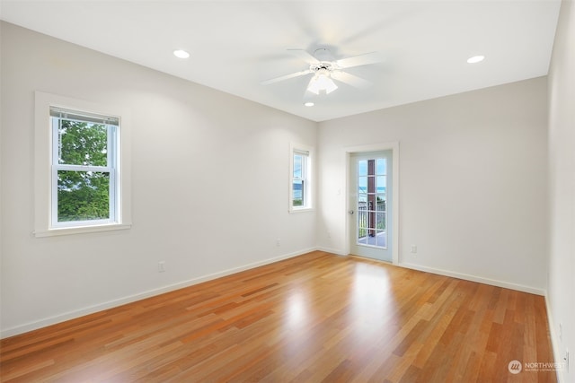 spare room featuring light hardwood / wood-style floors and ceiling fan