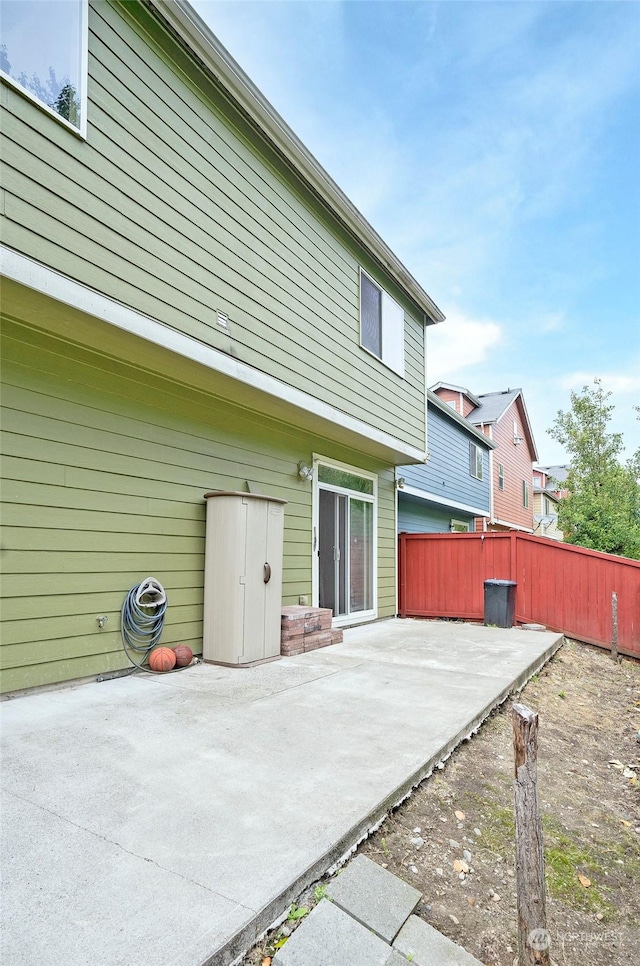 back of house featuring a patio and fence