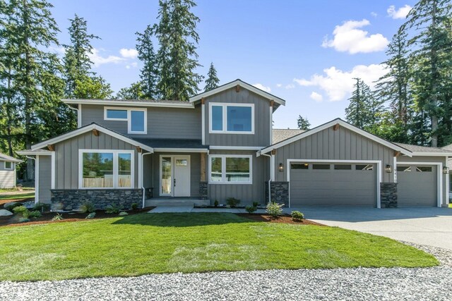 craftsman house with a garage and a front yard