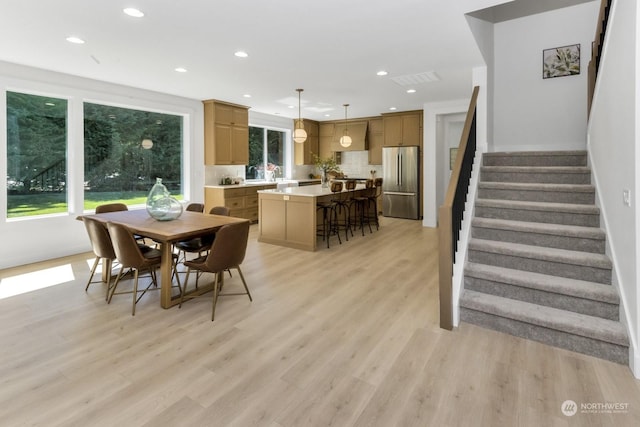 dining area with light wood-type flooring, visible vents, stairway, and recessed lighting