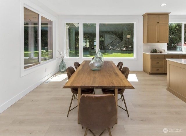 dining room featuring recessed lighting, light wood-type flooring, and baseboards