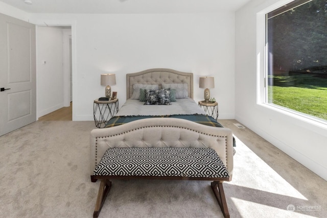 bedroom featuring carpet floors, visible vents, and baseboards