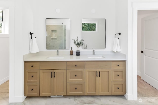 bathroom featuring plenty of natural light, a sink, and double vanity