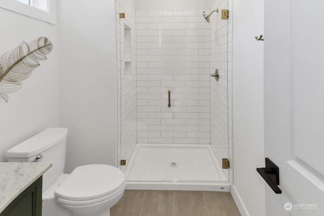 full bathroom with vanity, wood finished floors, a shower stall, and toilet