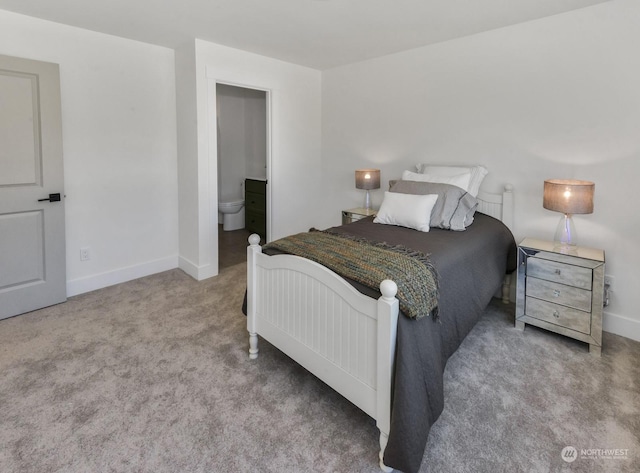 carpeted bedroom featuring baseboards and ensuite bathroom