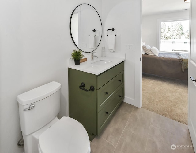 bathroom featuring toilet, vanity, ensuite bath, and tile patterned floors