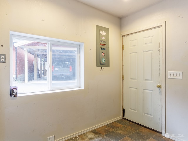 doorway to outside featuring dark tile patterned floors