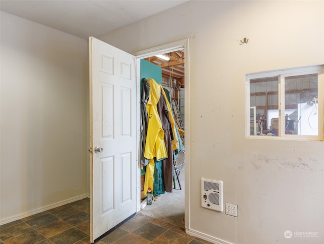 hall featuring dark tile patterned flooring