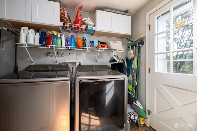 laundry room with separate washer and dryer and cabinets