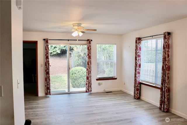 unfurnished room featuring ceiling fan and light wood-type flooring