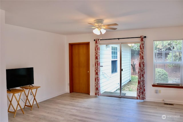 living room featuring ceiling fan, a healthy amount of sunlight, and light hardwood / wood-style floors