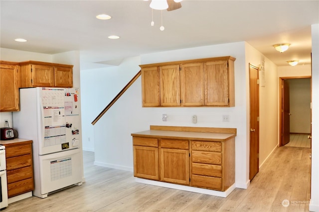 kitchen with light hardwood / wood-style floors and white refrigerator