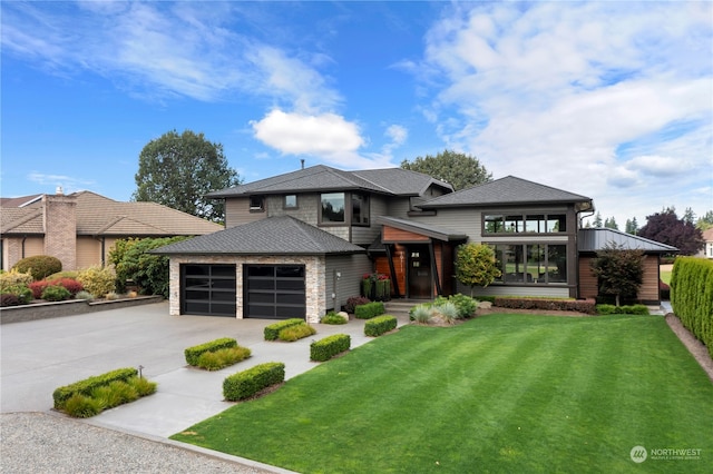 prairie-style home featuring a garage and a front yard