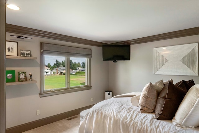 carpeted bedroom with ornamental molding