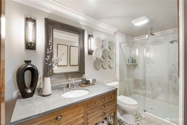 bathroom with crown molding, toilet, vanity, and a shower with shower door