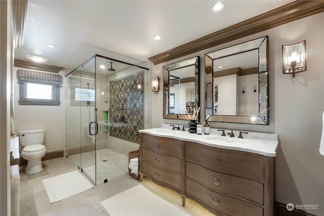 bathroom with double sink vanity, toilet, tile patterned floors, ornamental molding, and a shower with shower door