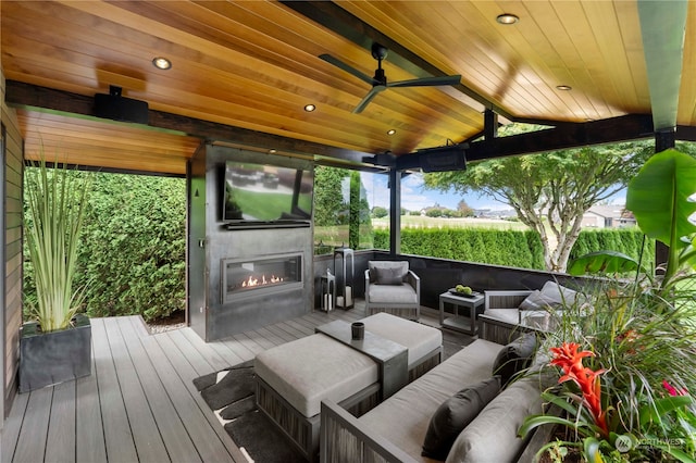 deck with outdoor lounge area and ceiling fan