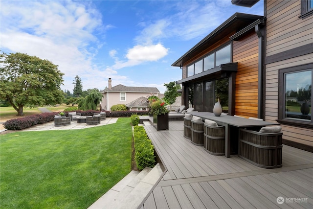 deck with a patio area, outdoor lounge area, and a lawn