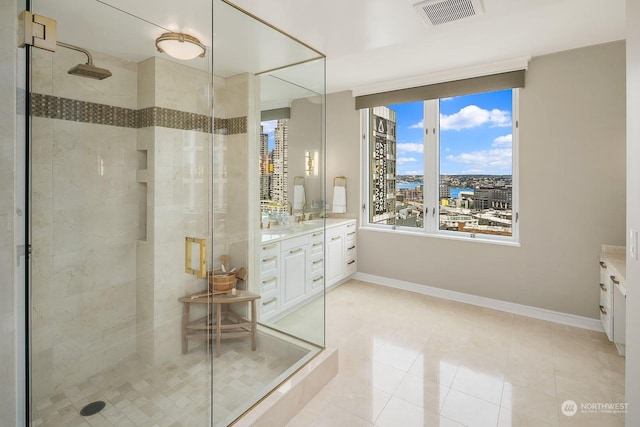 full bathroom with baseboards, visible vents, a city view, vanity, and a shower stall