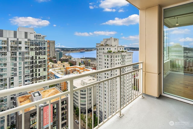 balcony with a water view and a city view