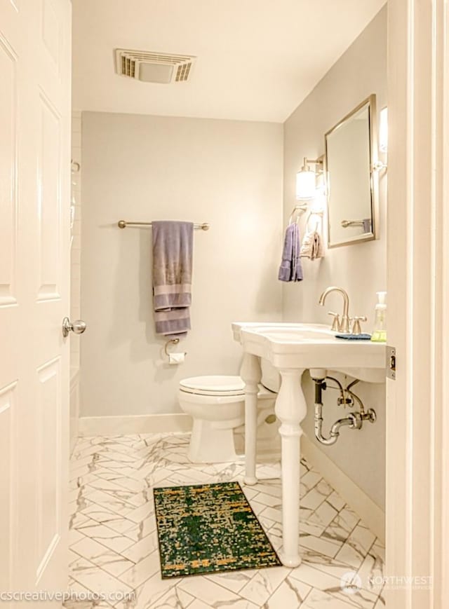 bathroom with visible vents, marble finish floor, toilet, and baseboards